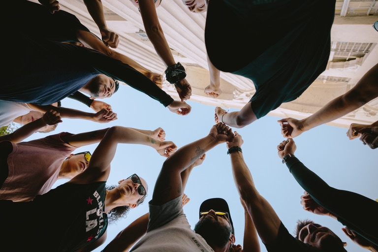 Runners putting their hands in before a group outing