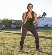 Person standing with a flex band around ankles