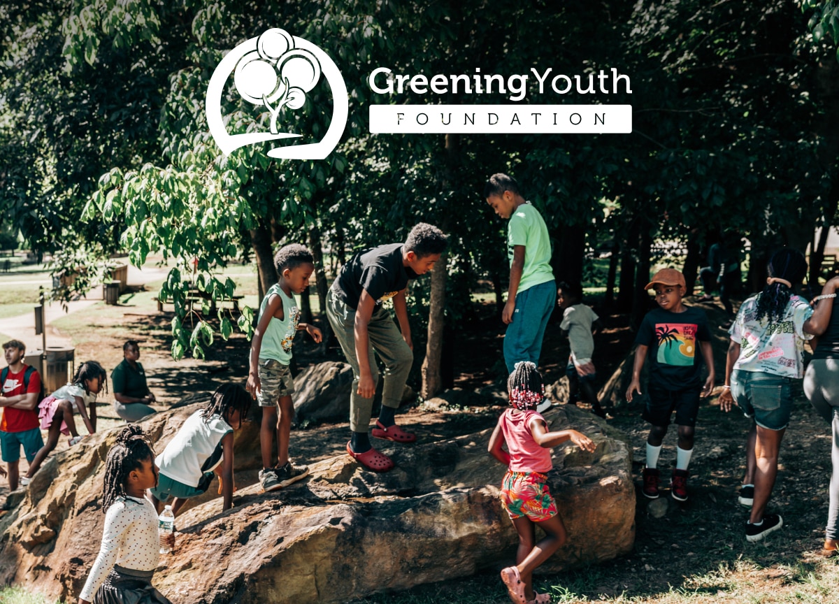 Kids playing outdoors on a rock. Text reads, Greening Youth Foundation.