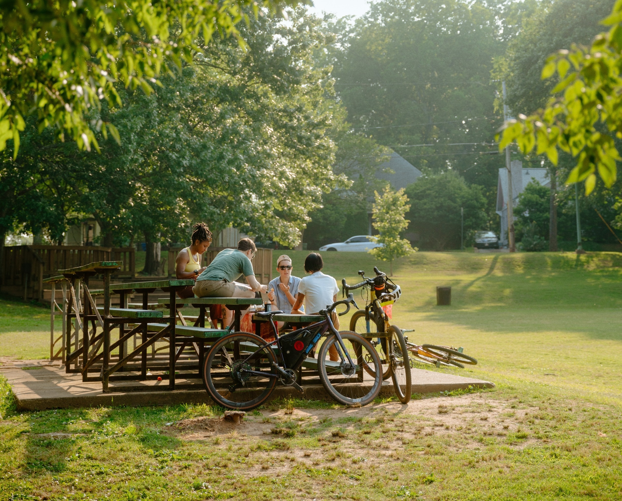 People gathered on bleachers in a city park with bikes.