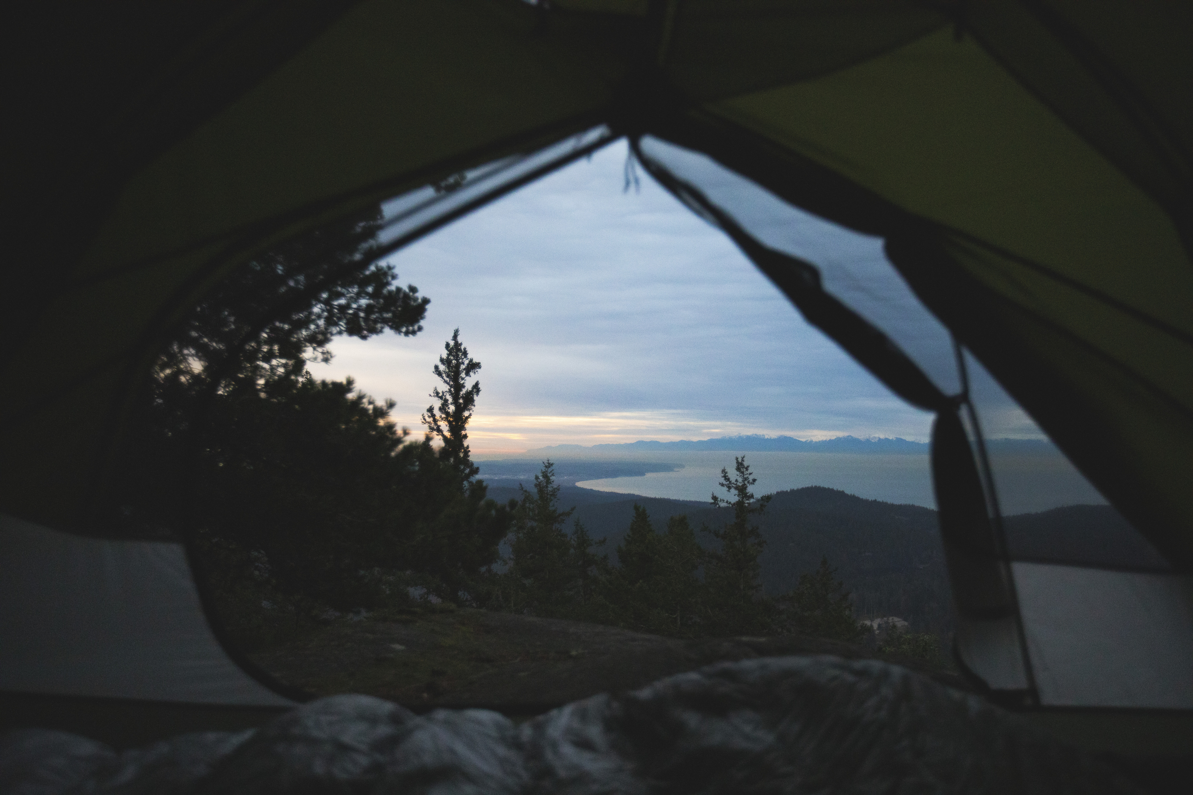 Looking through the door of a tent at sunrise.