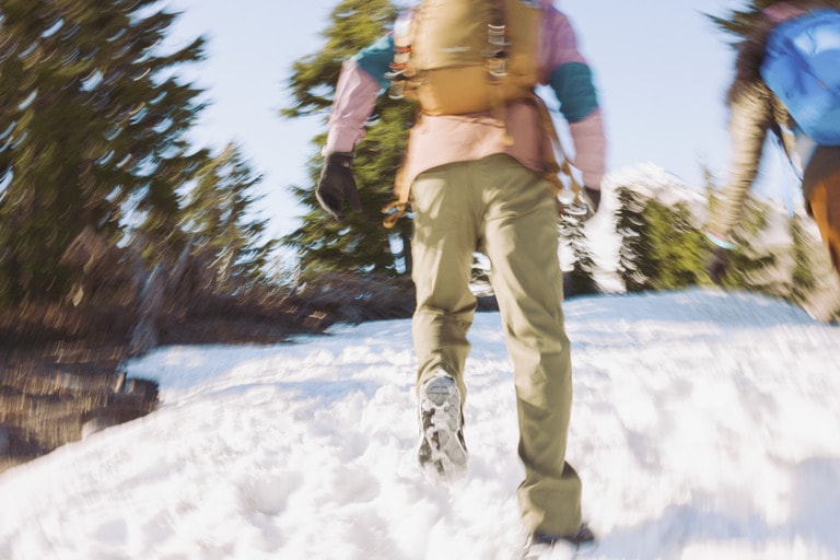 A person runs through a snowy landscape 