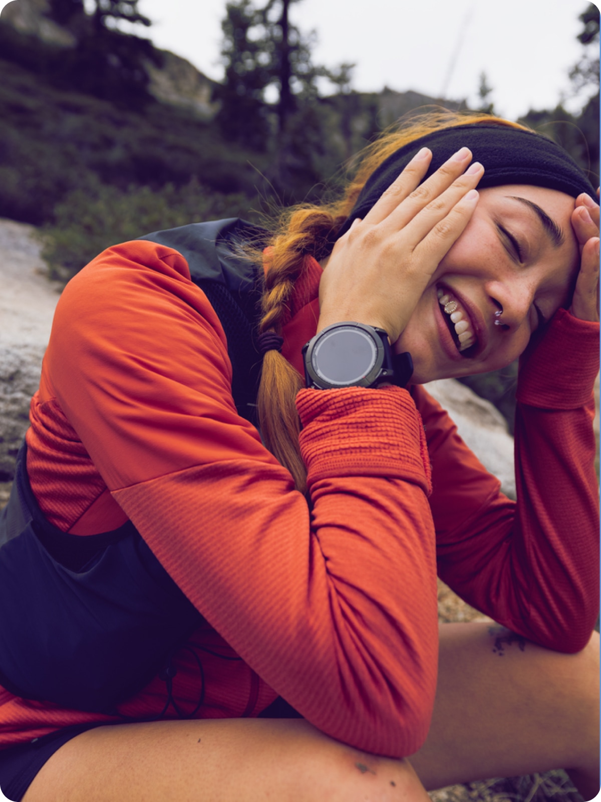 A hiker shows off their Garmin watch to the camera.