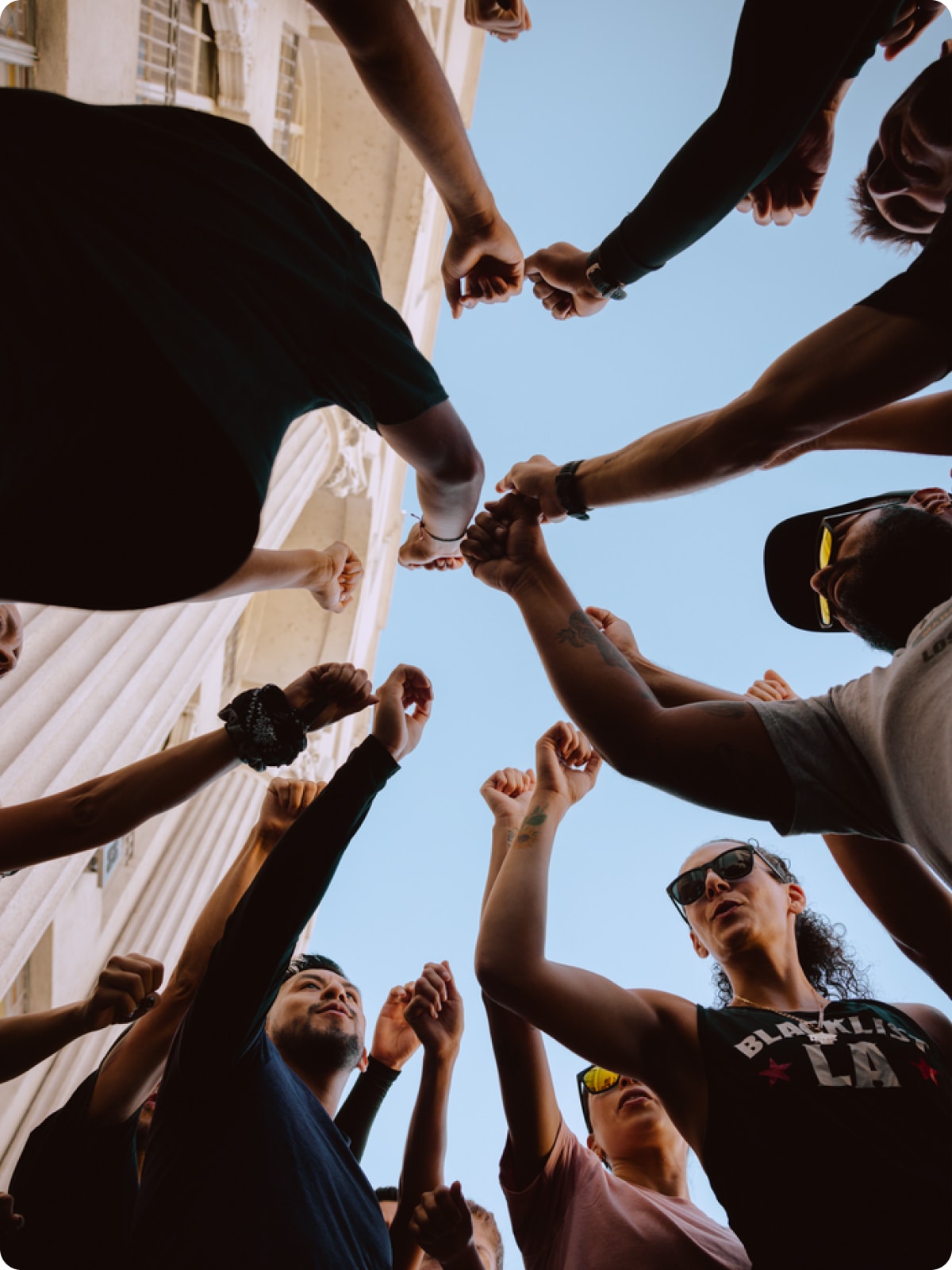 A group of people putting their hands together.