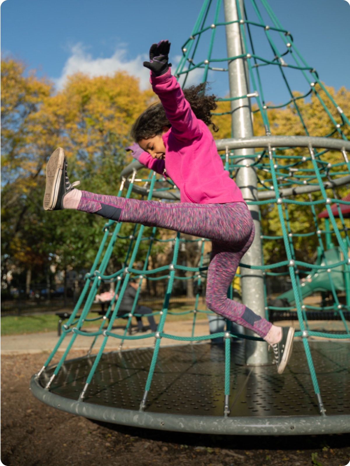 A child jumping at a schoolyard.