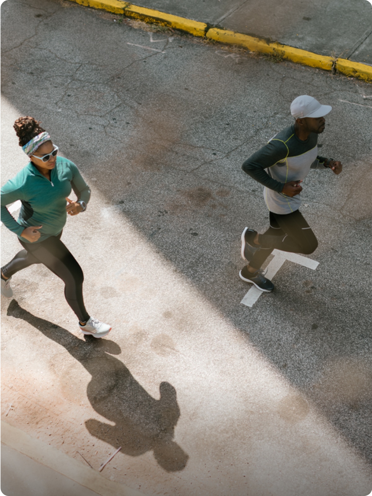 Two people running in the city.