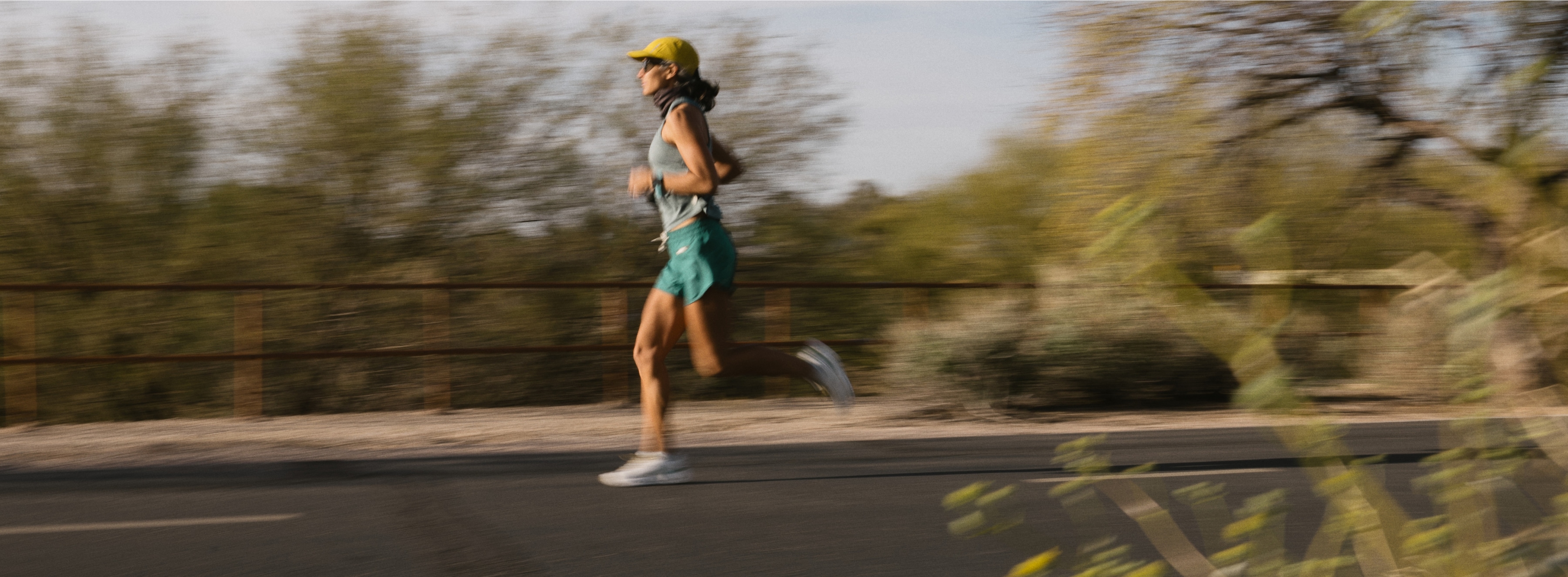 A runner on a sunlit path.