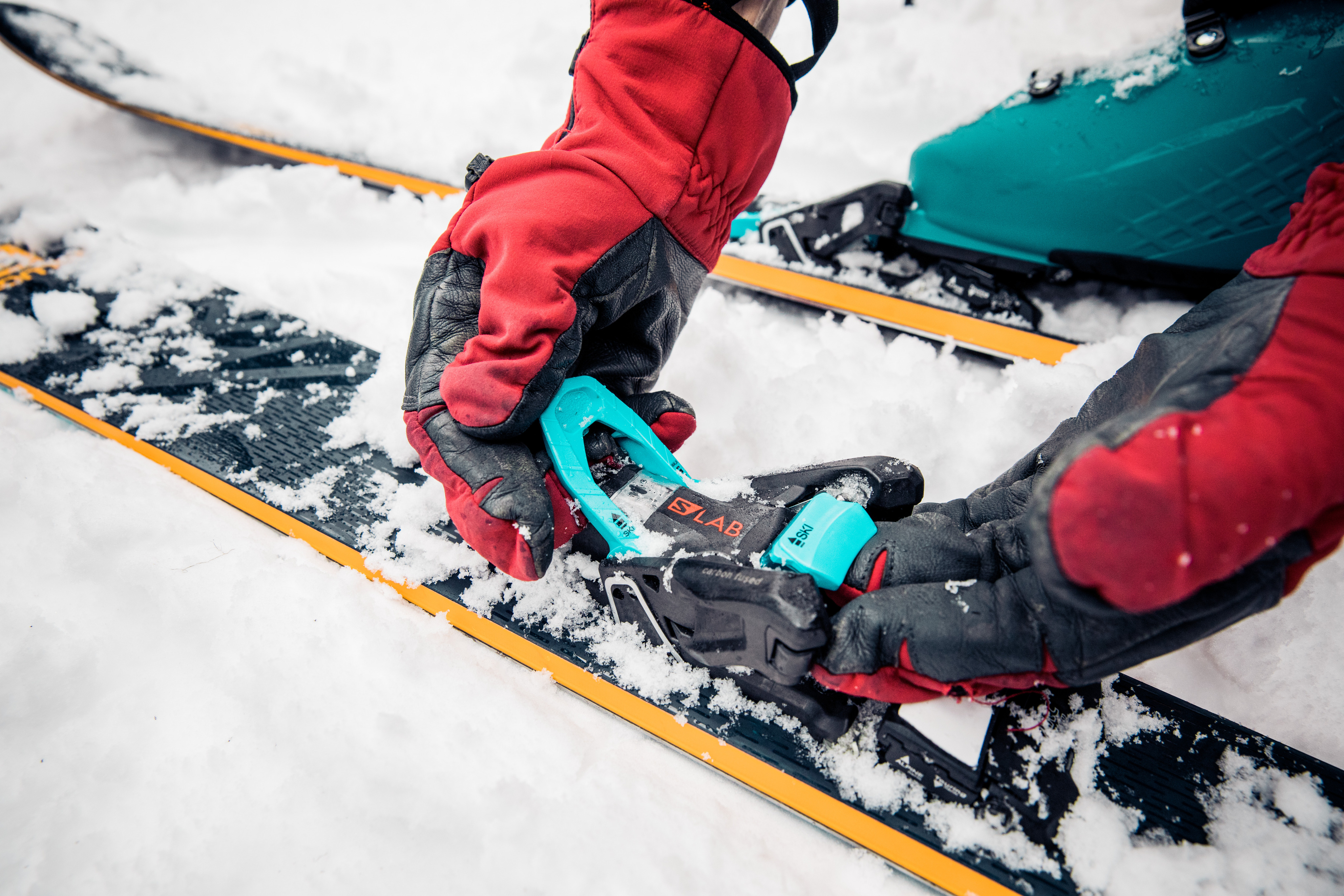 Skier fixes binding in the snow