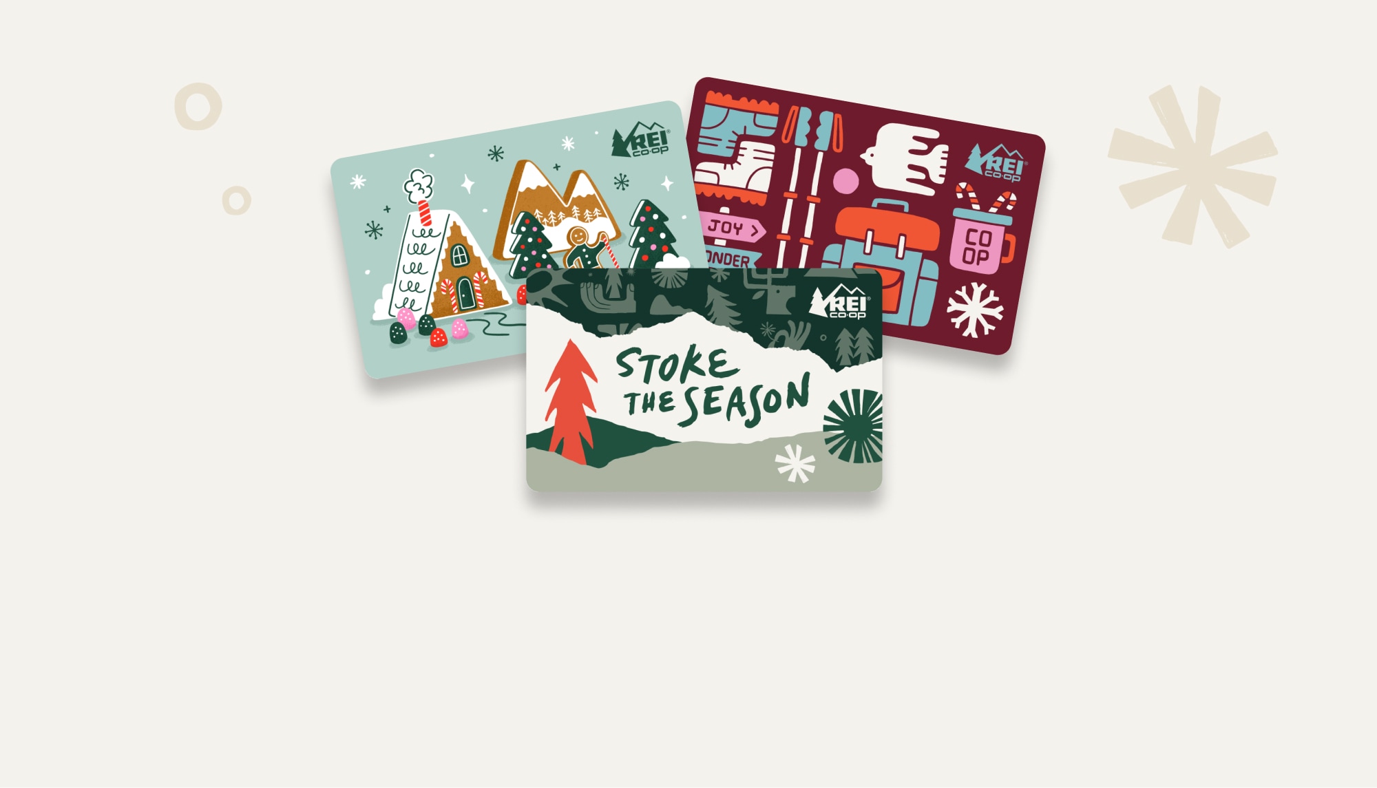 R E I gift cards with holiday designs.