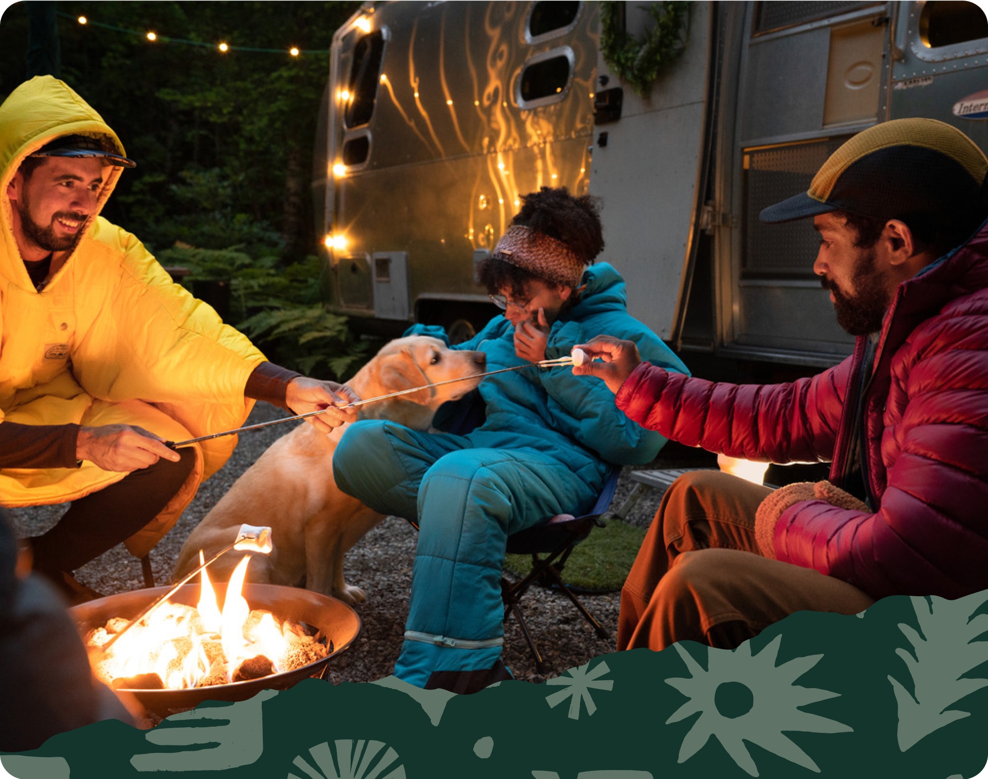 Campers enjoy s’mores around a campfire with a very good pup.