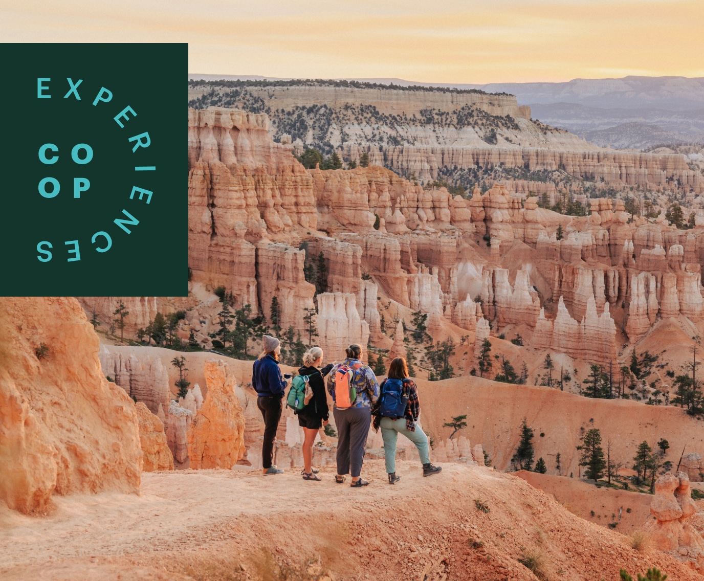 Hikers watch the sun rise over Bryce Canyon.