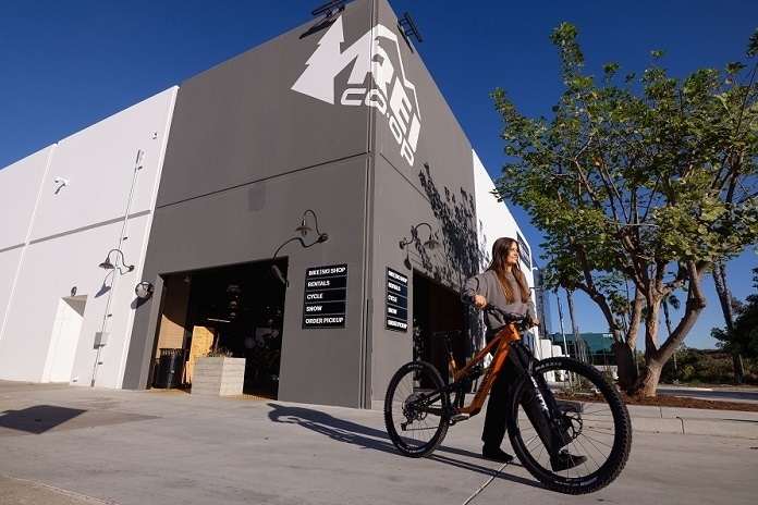 Canyon Bicycle being wheeled out of REI Co-op store