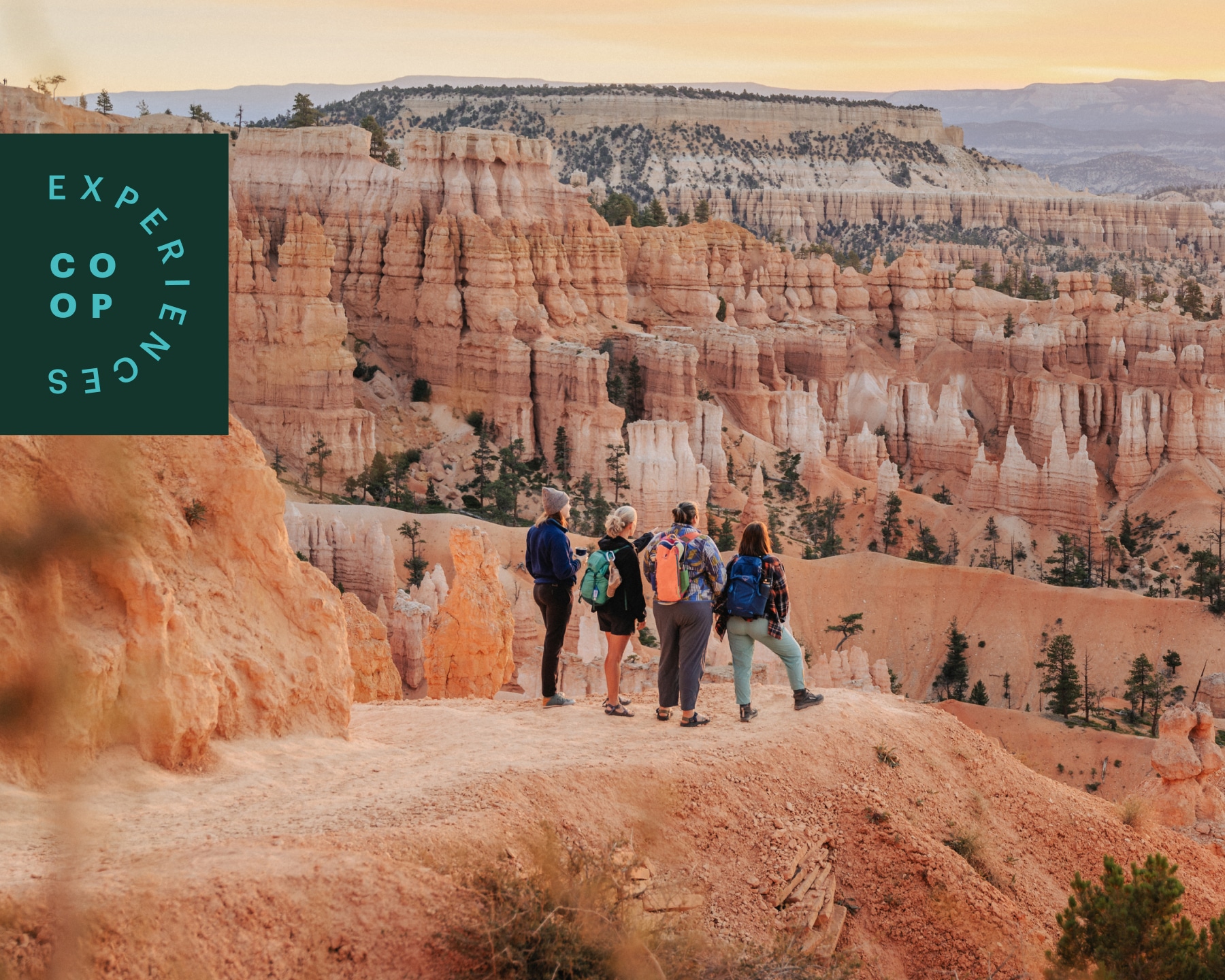 Hikers watch the sun rise over Bryce Canyon.