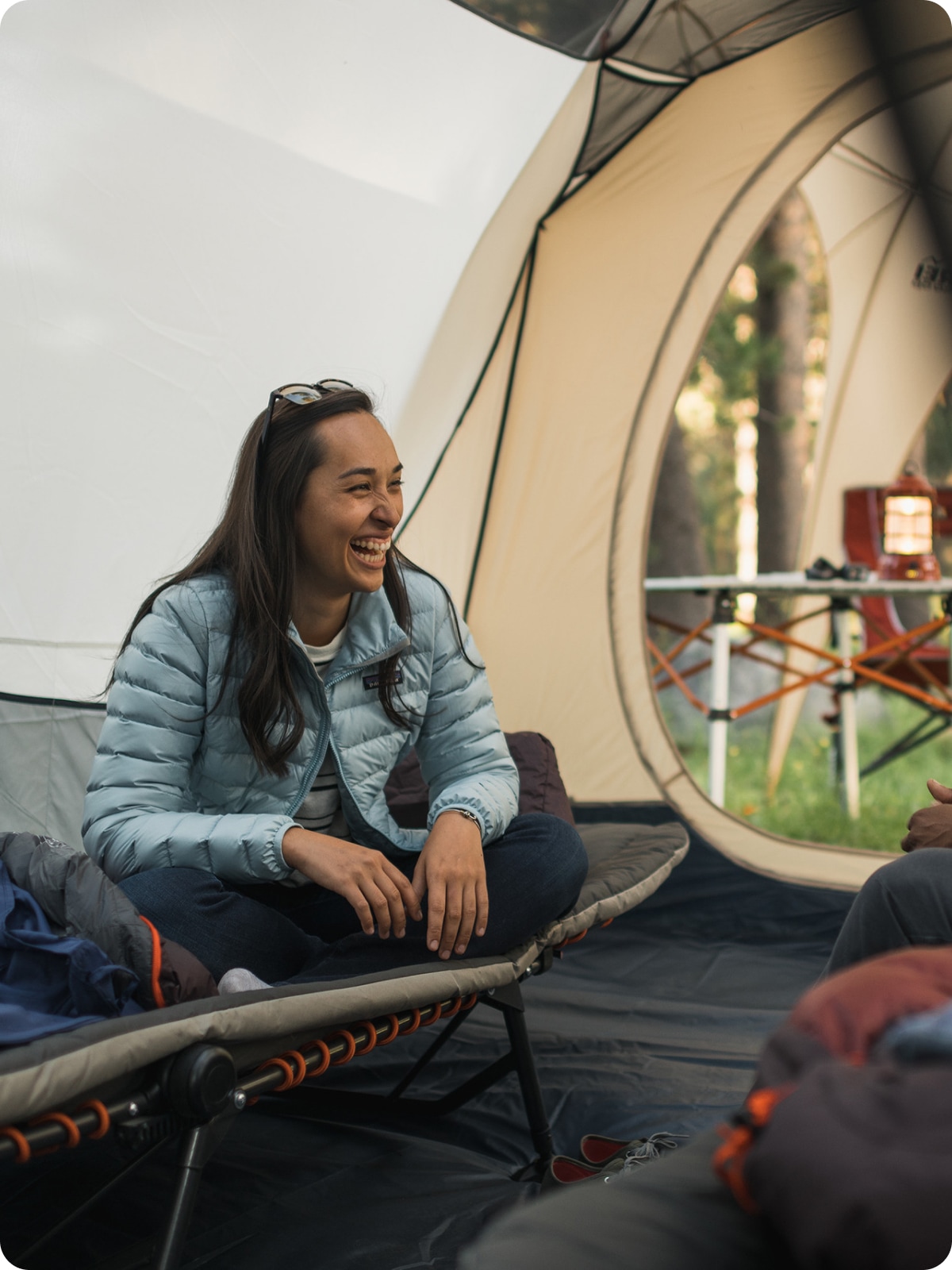 Campers laughing in a tent.