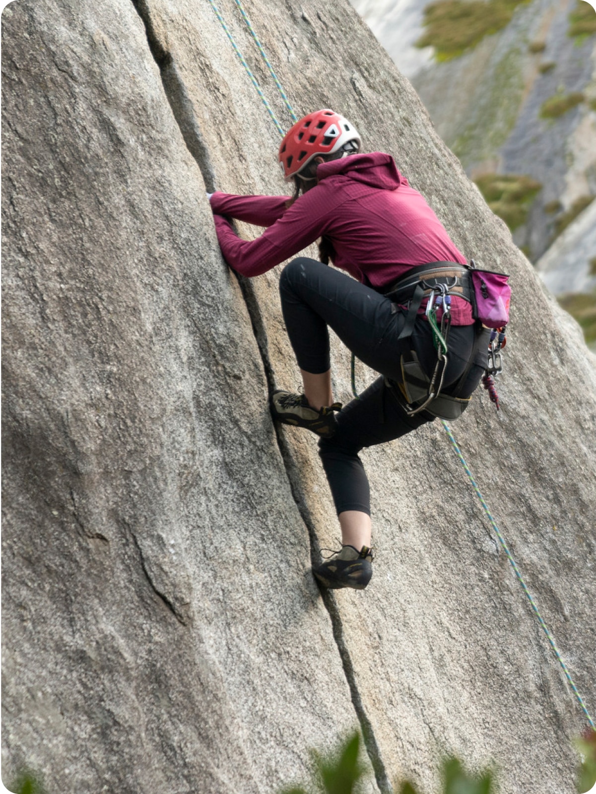 A climber scales a steep rock face.