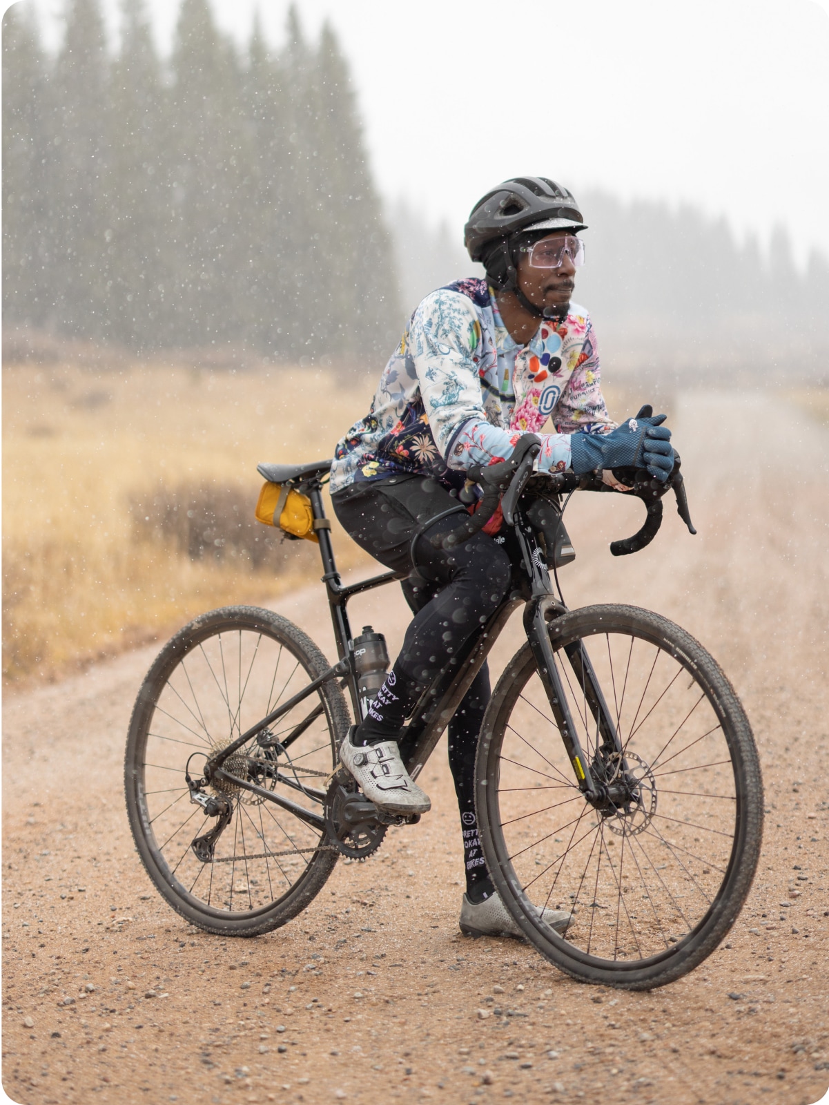 A cyclist takes a break on a trail.