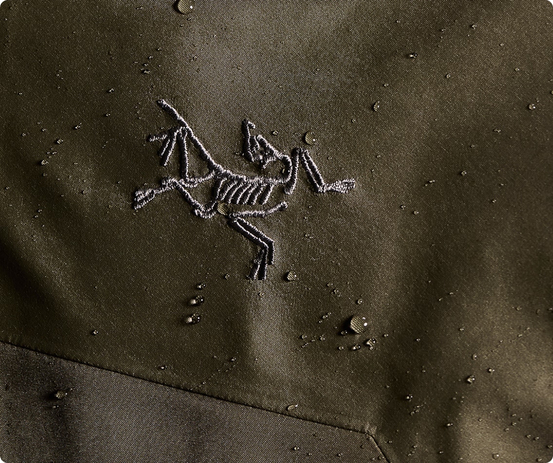 The Arc’teryx logo on water-dappled fabric.