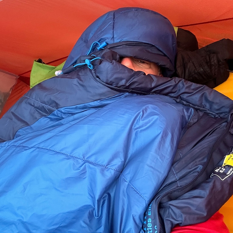 A person wrapped up in a cozy sleeping bag.