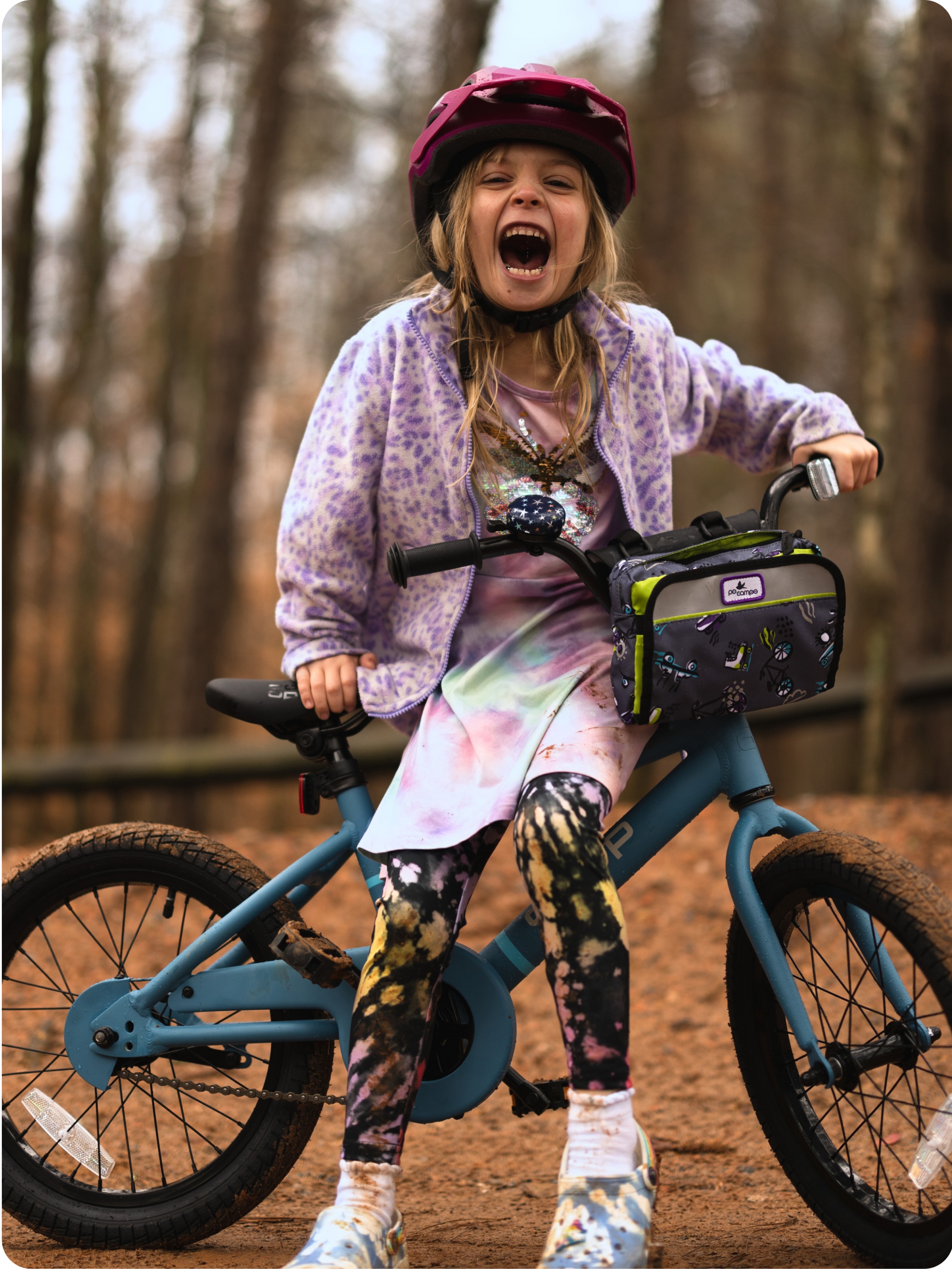 A child laughing on a bike.