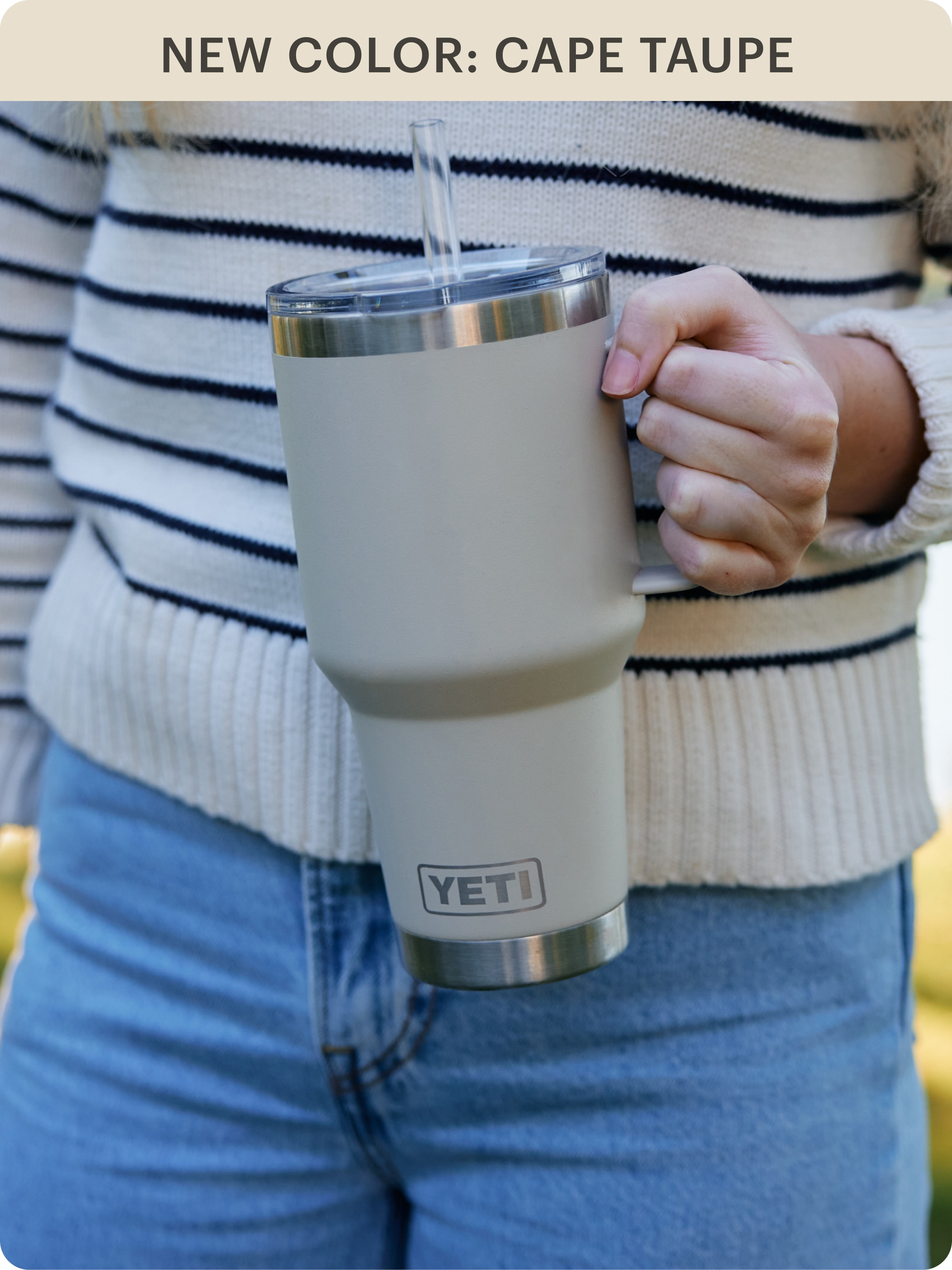 A person holds a YETI Rambler mug.