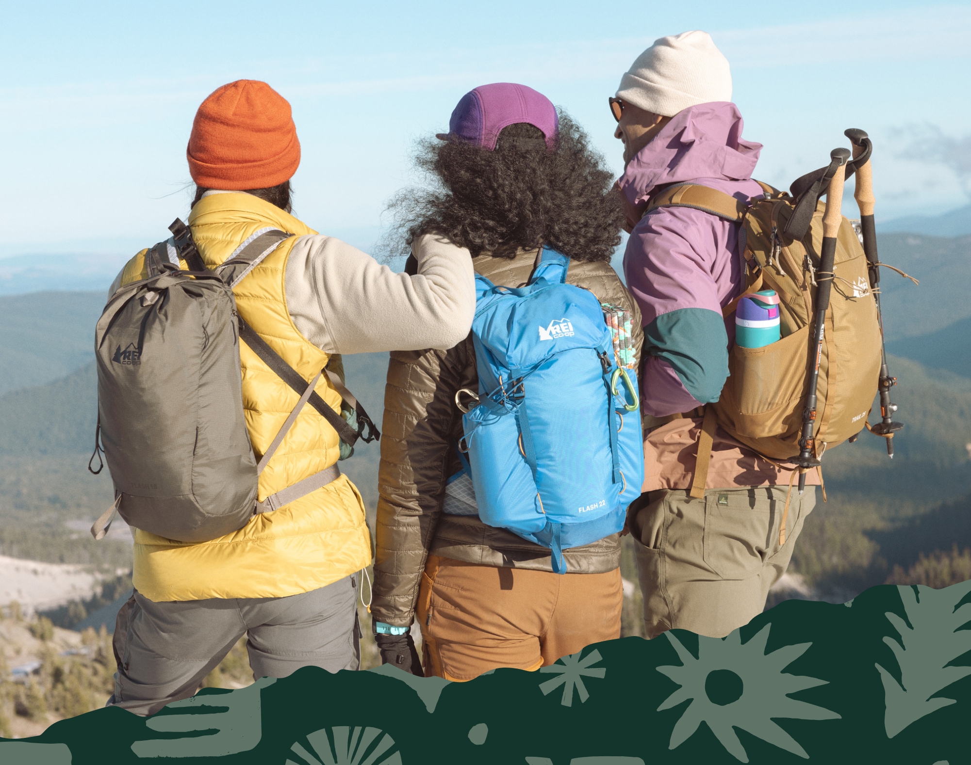 Three people stand on top of a viewpoint with their backs to the camera.