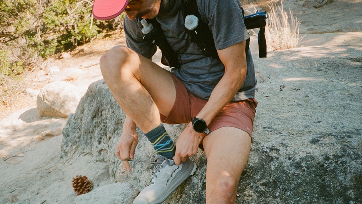 A trail runner wearing a GPS watch