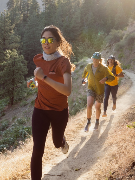 A group of trail runners on a forest path.