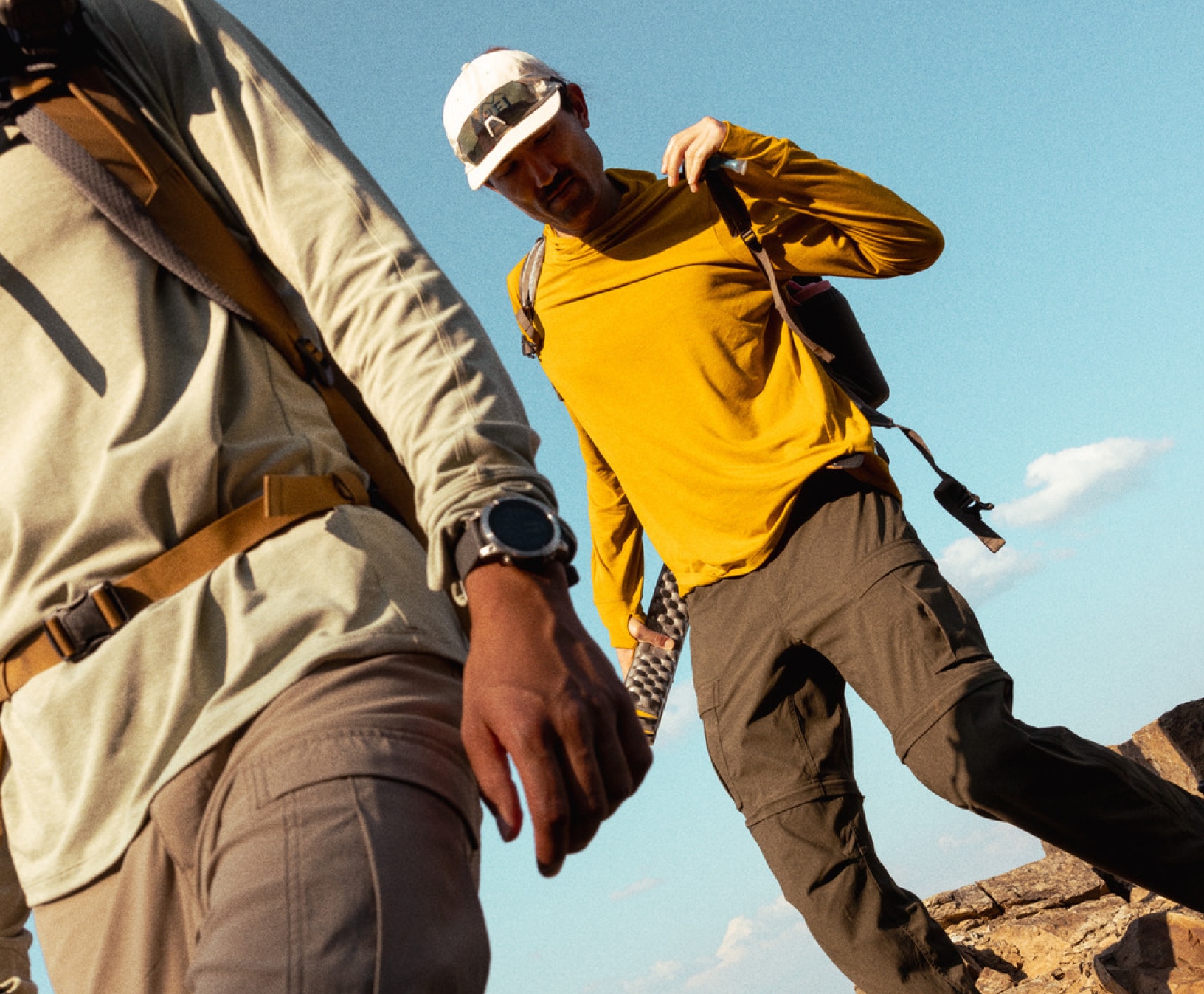 Hikers wearing backpacks on a trail.