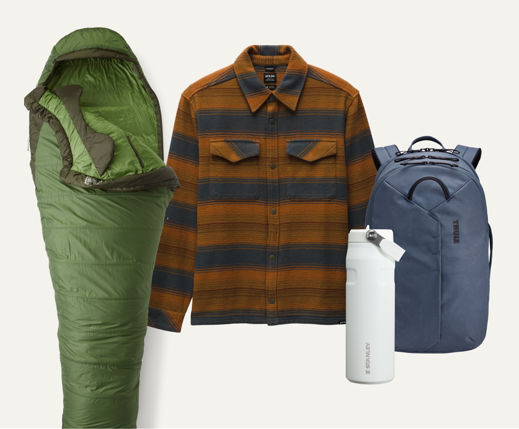 An assortment of outdoor gear including a backpack, water bottle, flannel shirt, and sleeping bag.