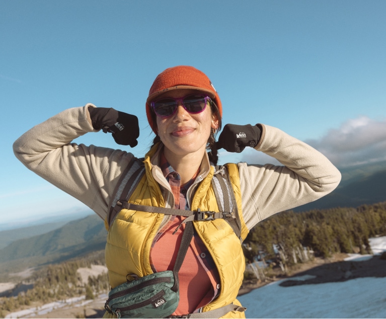 A hiker in winter gear poses for the camera.