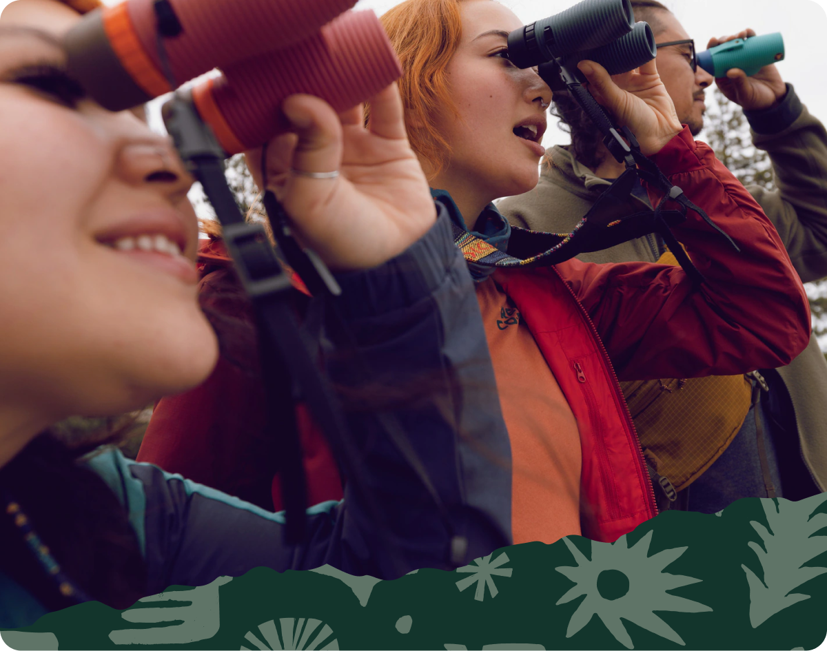 Three people looking through their Nocs Provisions binoculars.