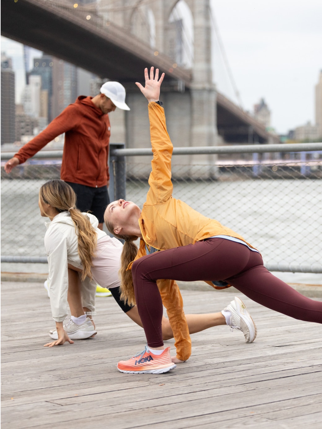 People doing yoga near the Brooklyn Bridge.