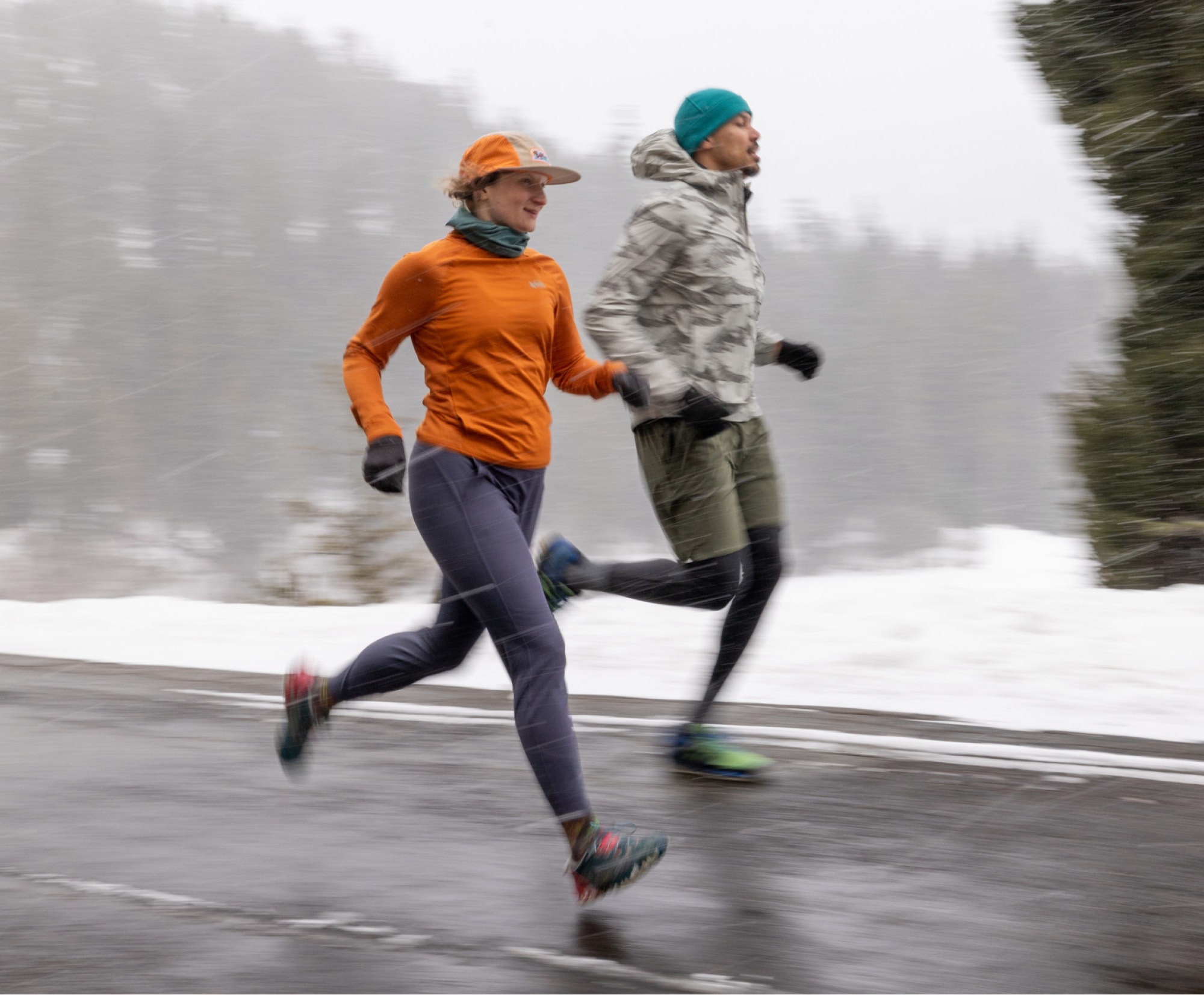 Two people running on a snowy day.