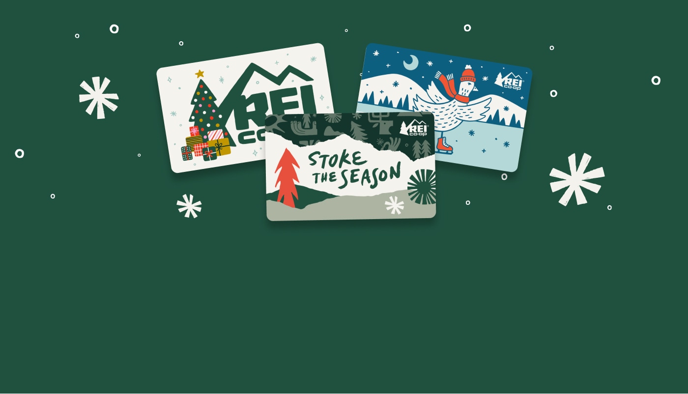 R E I gift cards with holiday illustrations.