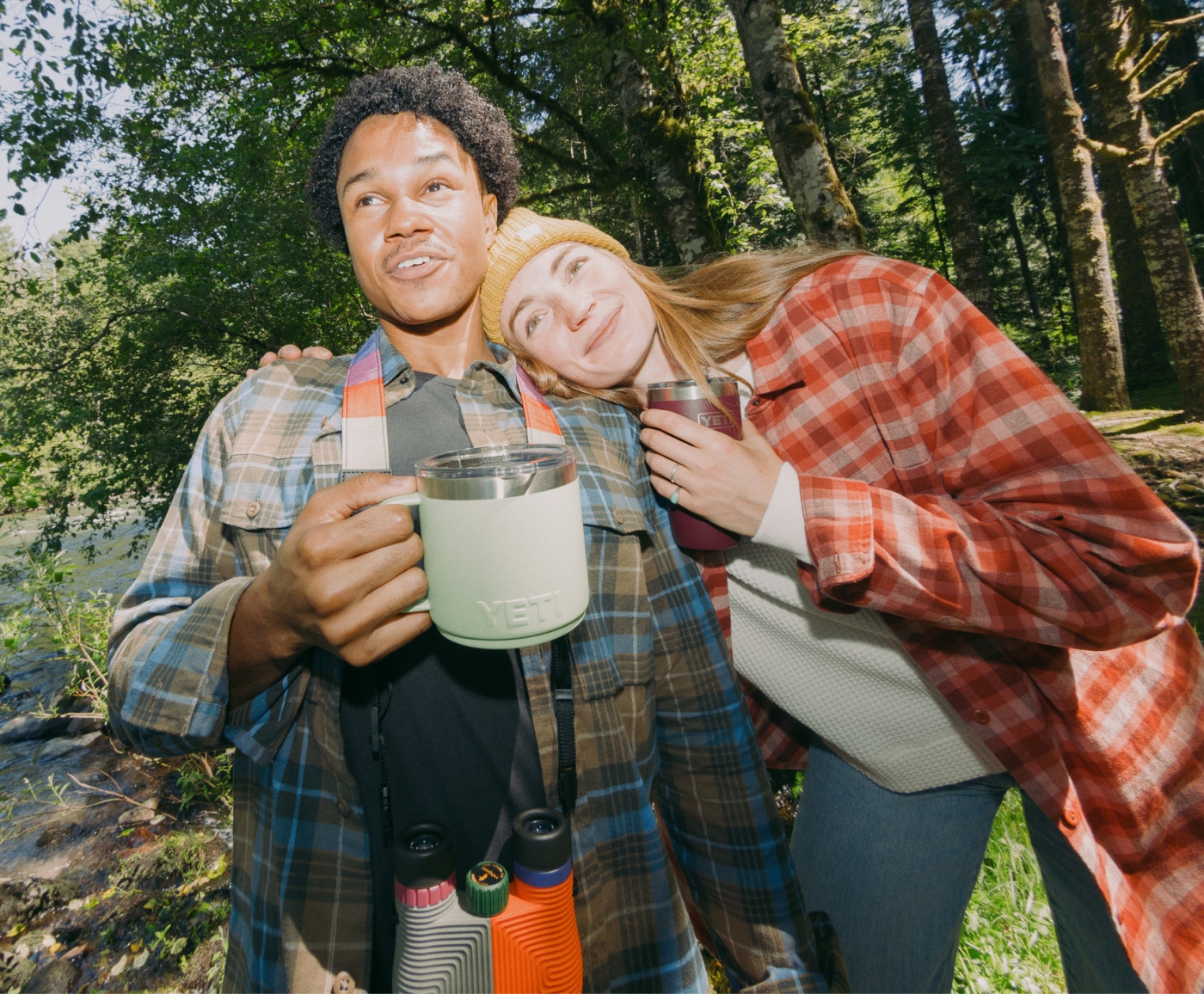 Two people enjoying the outdoors with their YETI cups.