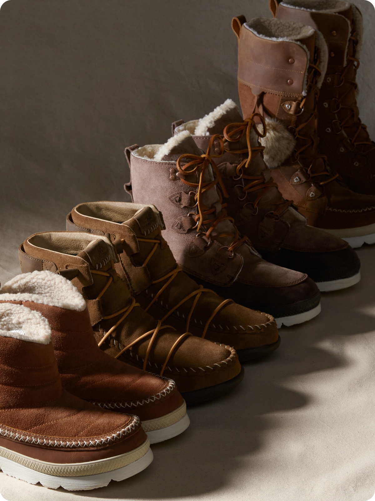 Four pairs of cozy winter boots lined up in a row.