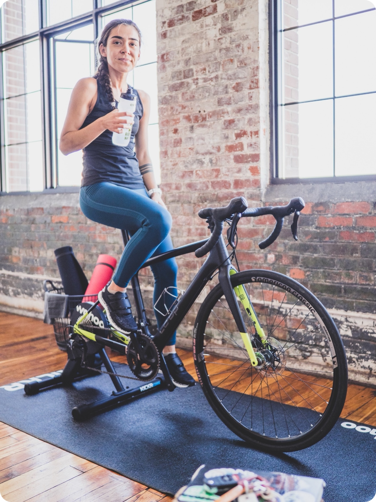 A person poses for the camera on their indoor cycling setup.