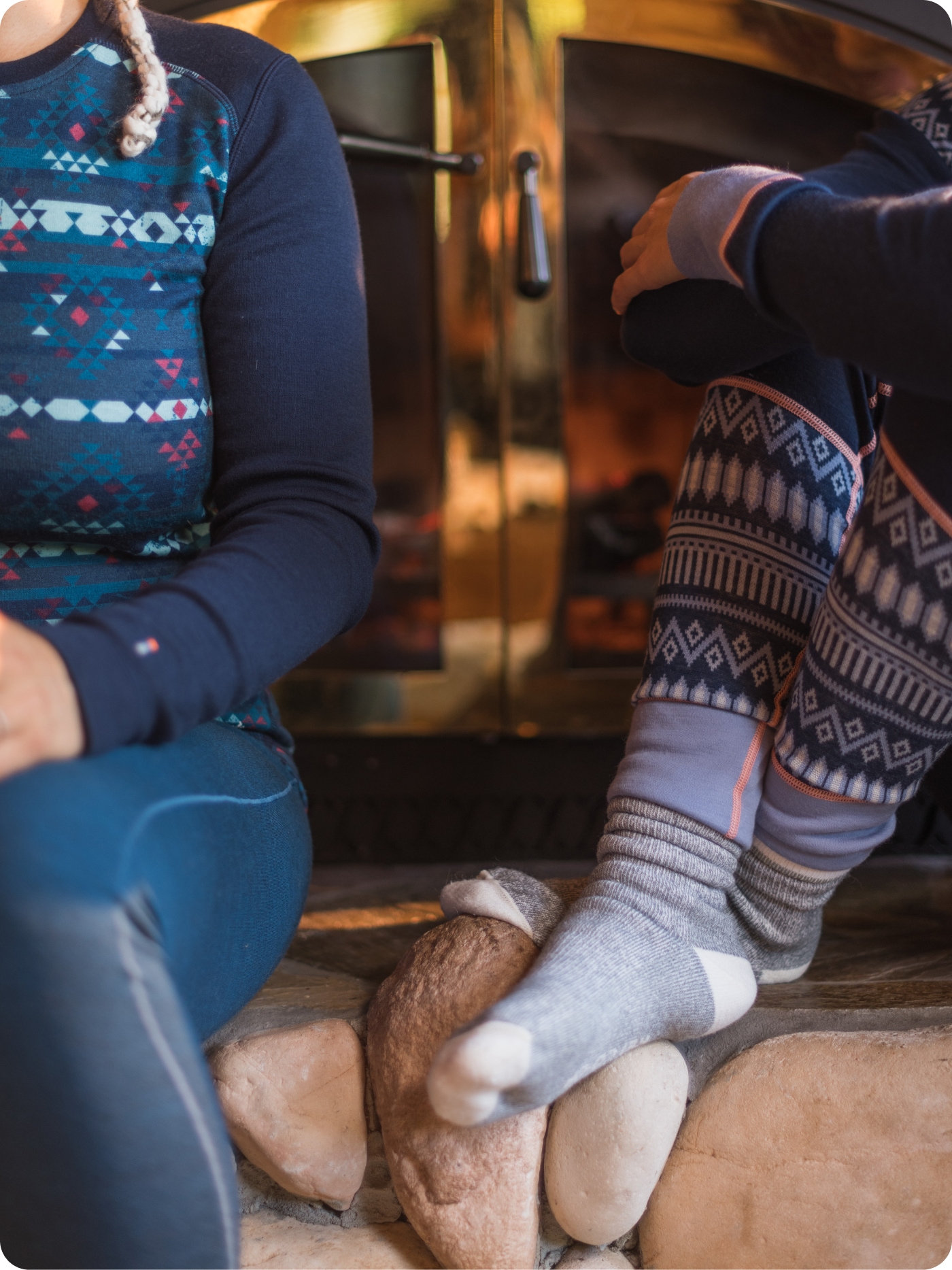 Two people relaxing in cozy winter base layers.