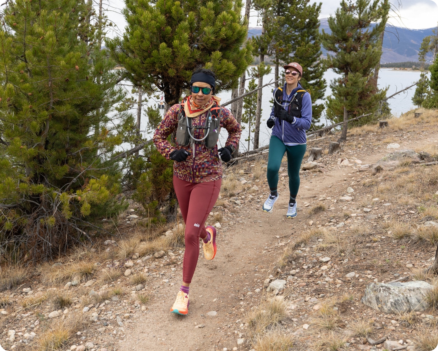 Runners cruise down a rocky trail on a chilly day.