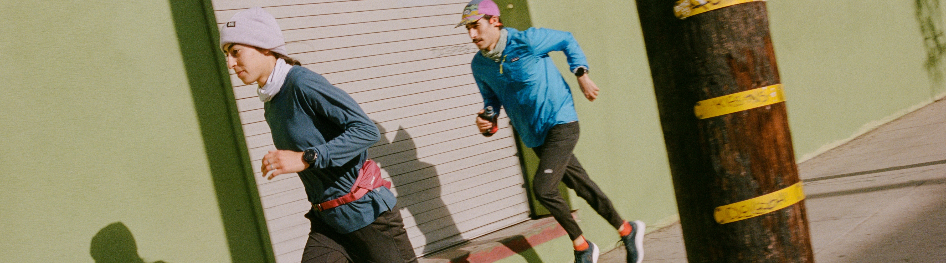 Two people running on a sunny day.