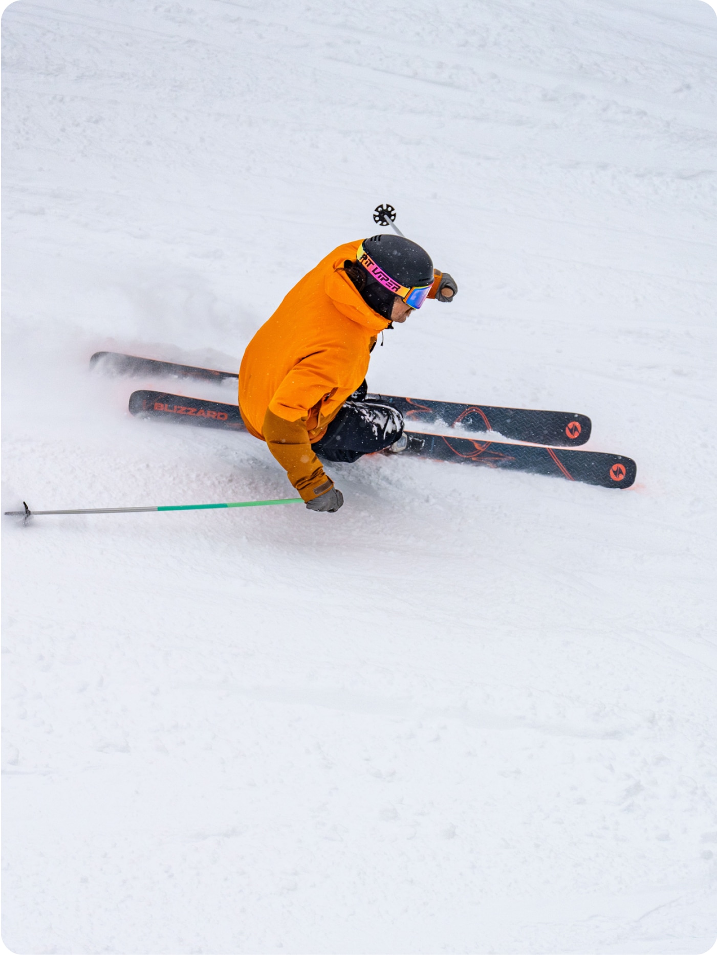 A skier skis down a snowy mountain.