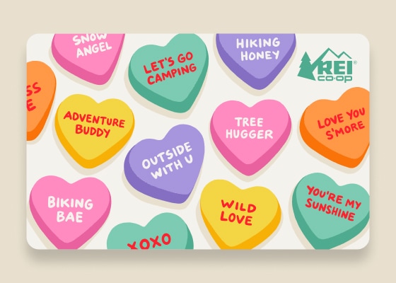 An R E I gift card designed with custom conversation hearts. One of the hearts says 'love you s'more.' Get it?