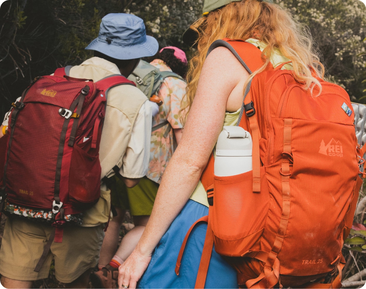 A trio of hikers with their R E I Co-op backpacks.