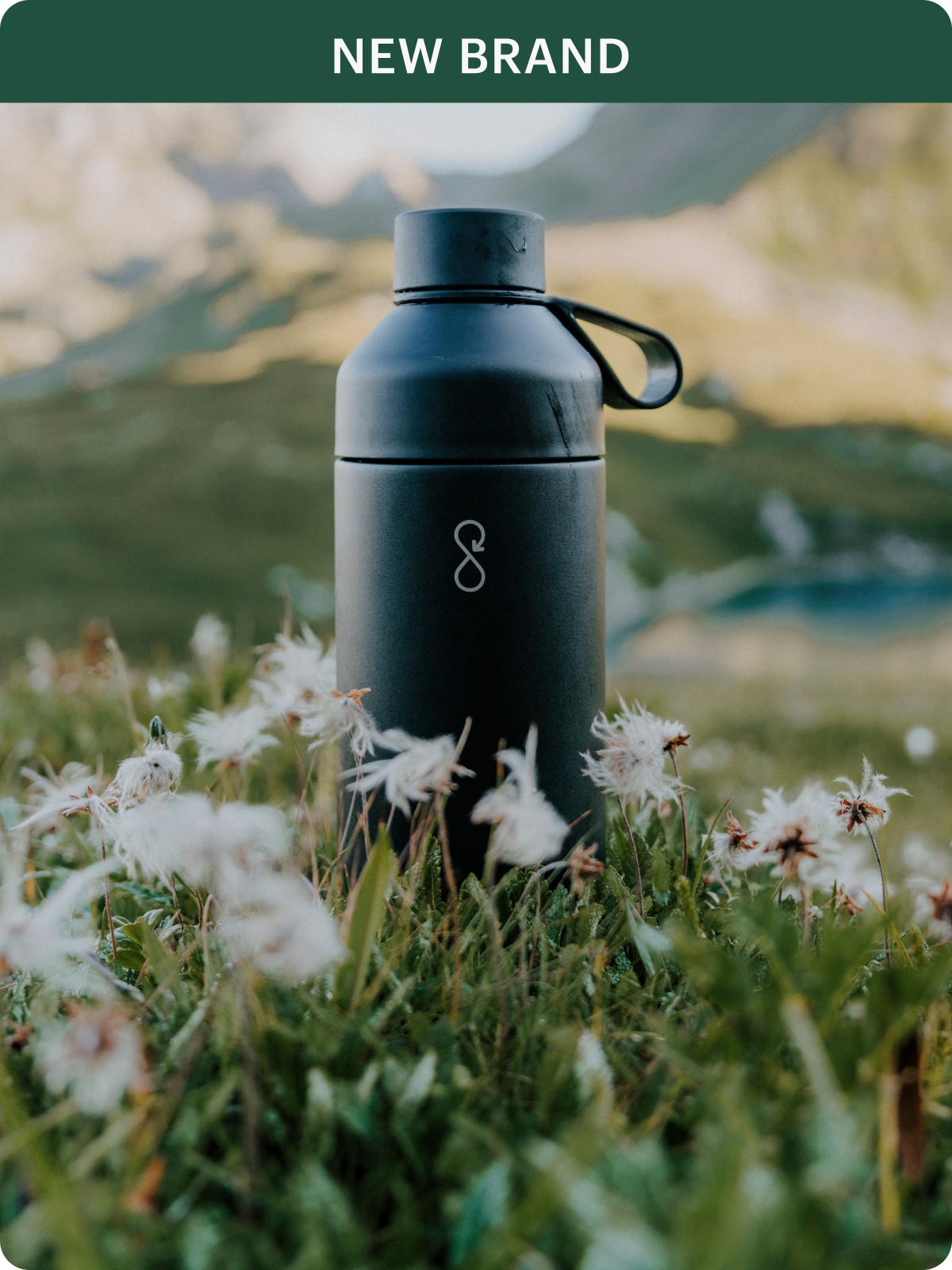 The Original Vacuum Bottle by Ocean Bottle sitting in a field of flowers.