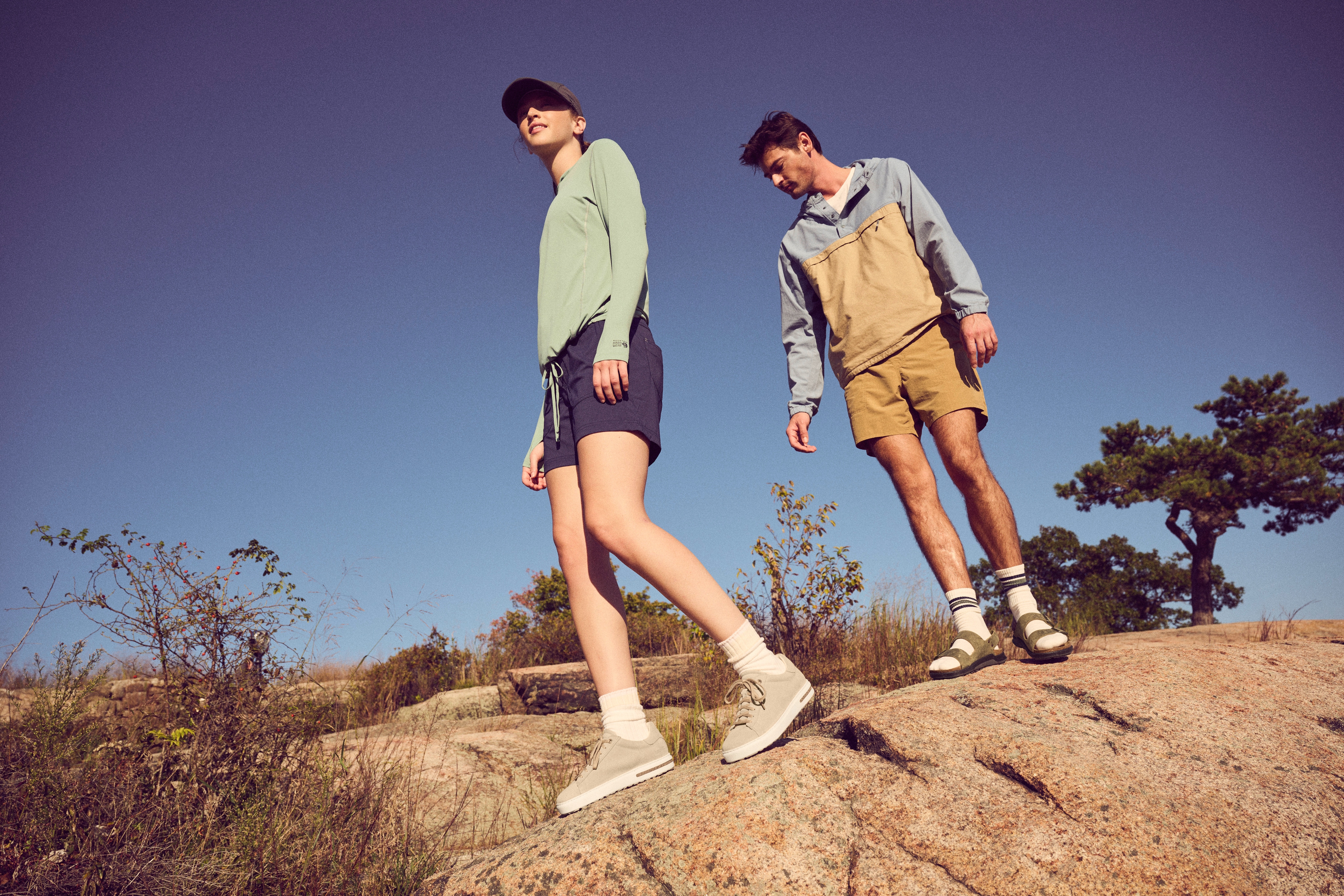 Two people wearing Birkenstock shoes outdoors.