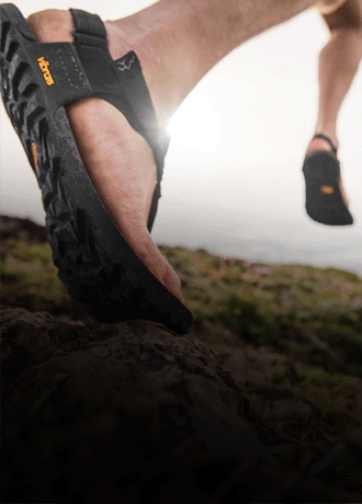 Two people on a trail wearing Bedrock sandals