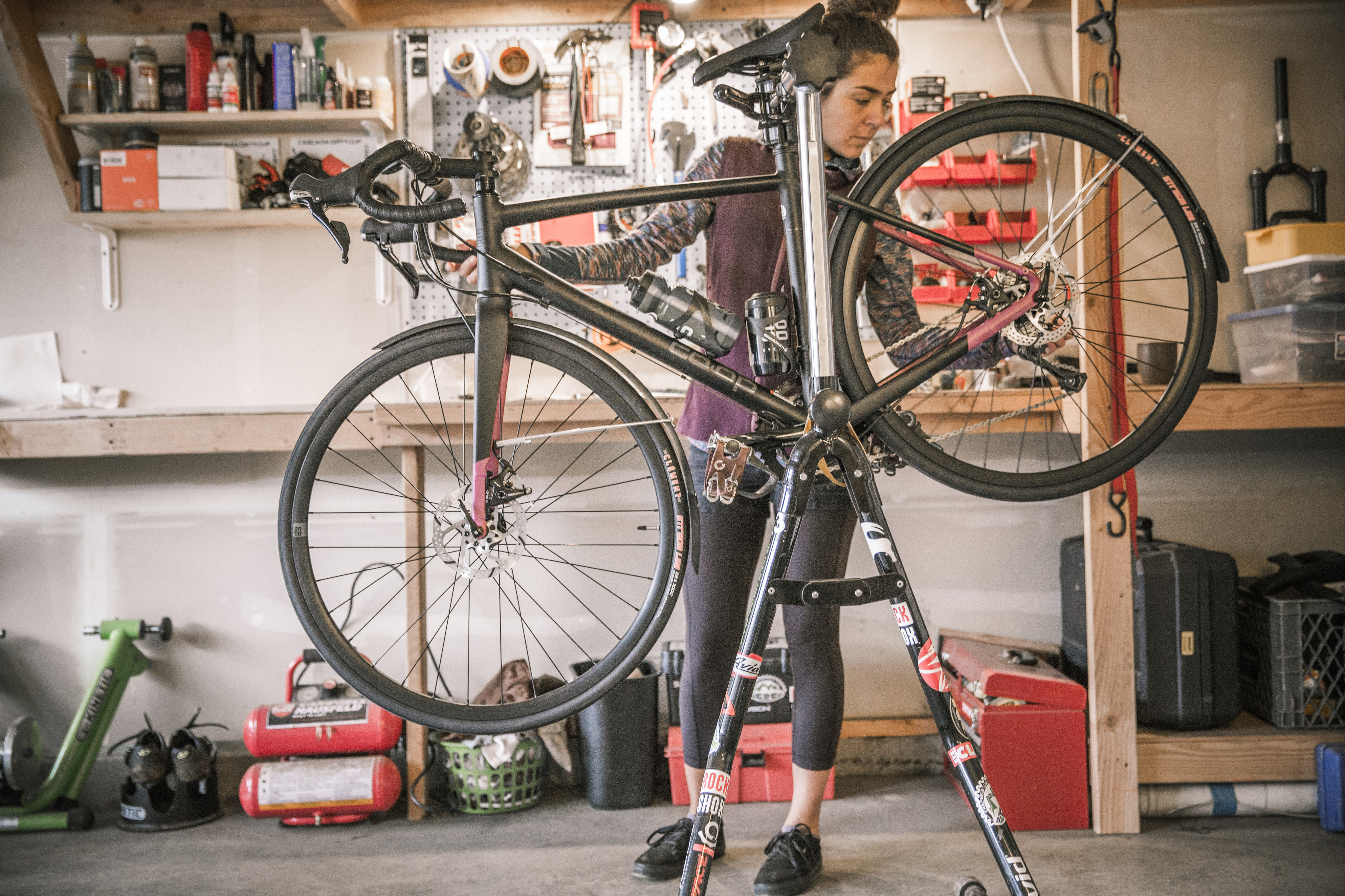 R E I employee fixing a bike