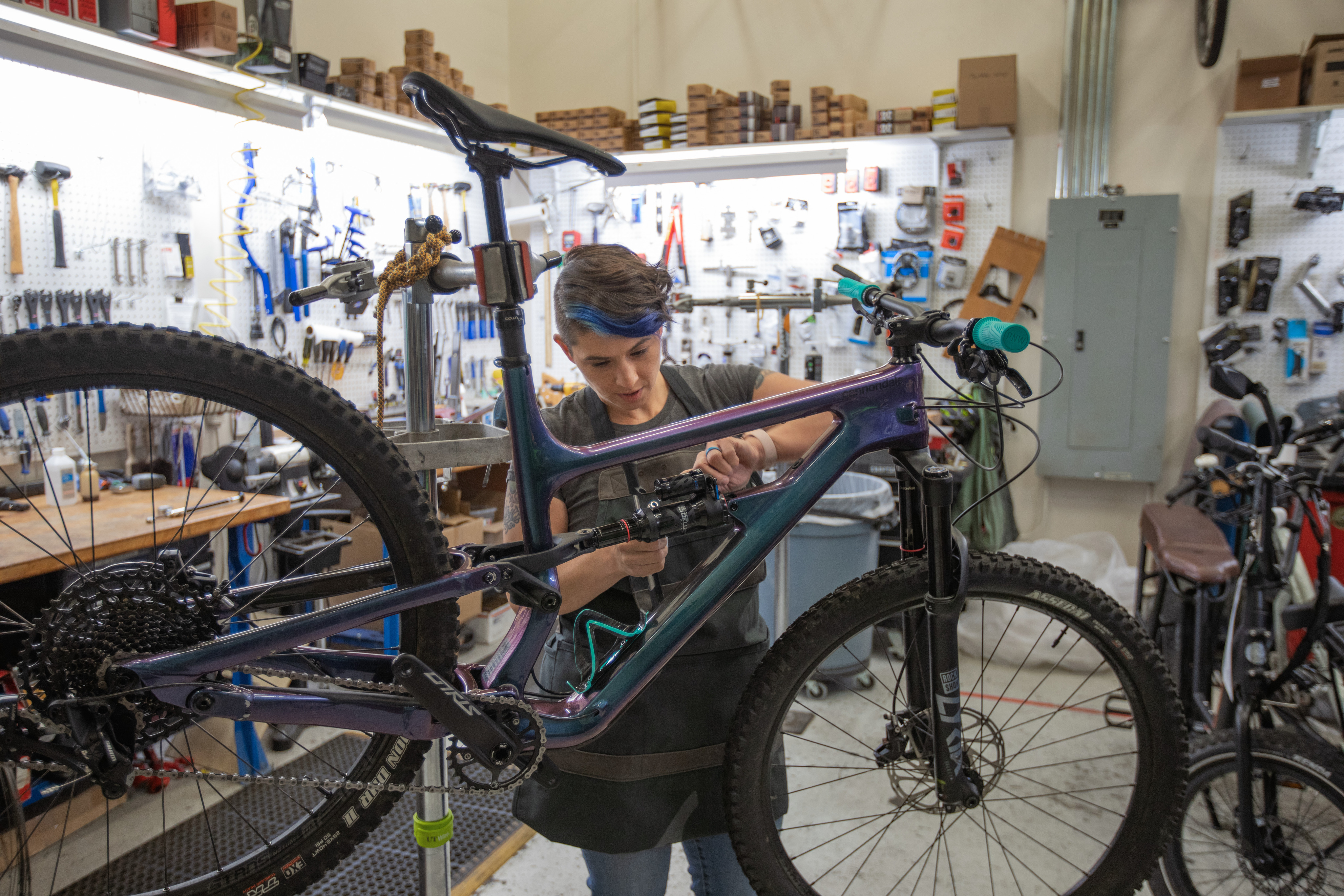 R E I employee fixing a bike