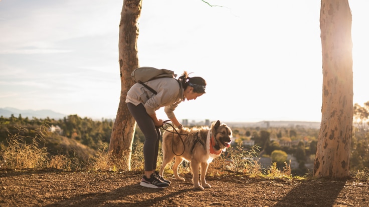 Woman and dog on hike sunrise