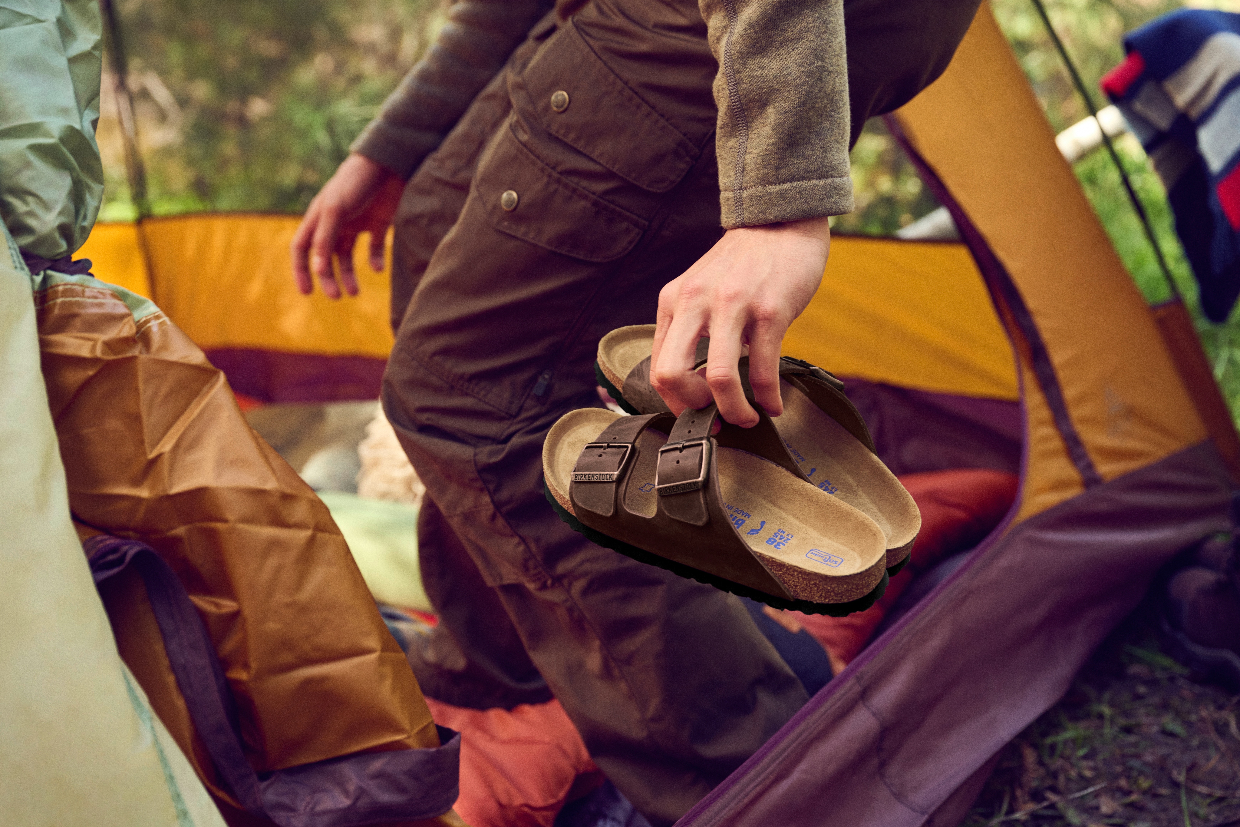 A camper carrying Birkenstock Arizona sandals.